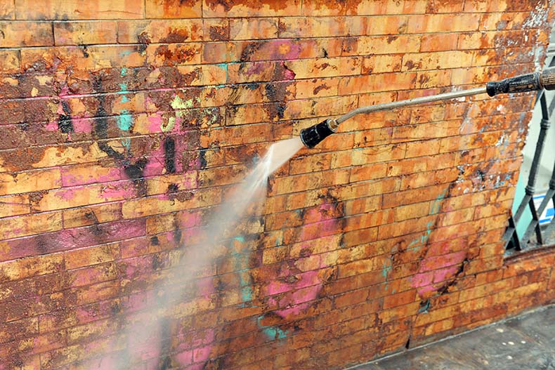 water spray to remove graffiti from brick walls